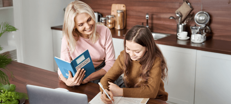 Image of a teacher helping a young person