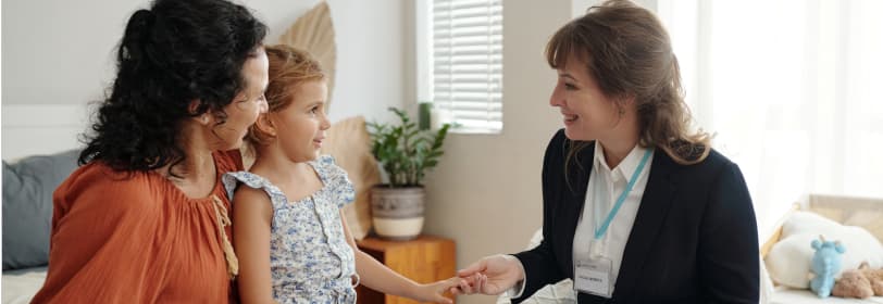 Image of a teacher talking to a young person and parent